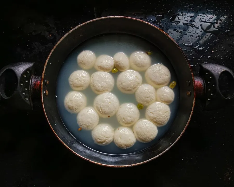 Rasgulla simmering in cardamom syrup